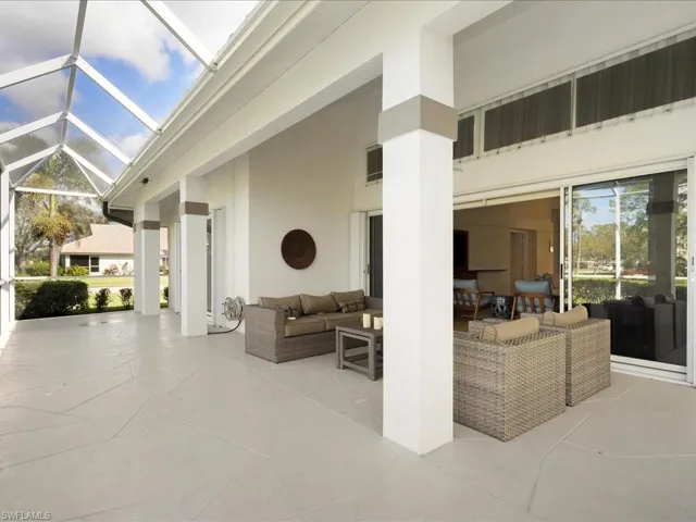 View of patio with an outdoor living space and a lanai