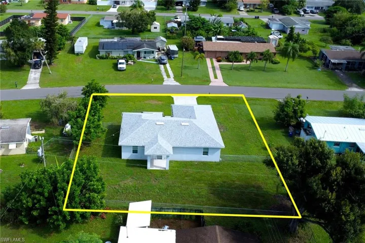 Aerial view of residential area with property boundaries highlighted