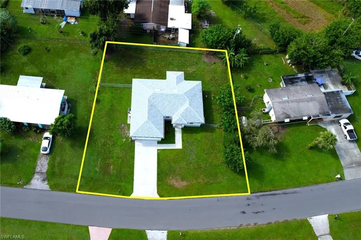 Aerial perspective of suburban area featuring property parcel outlined