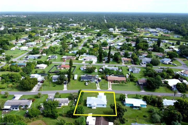 Aerial view of residential area with property parcel outlined