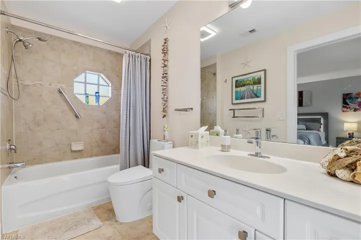 Full guest bathroom featuring vanity, connected bathroom, shower / bath combination