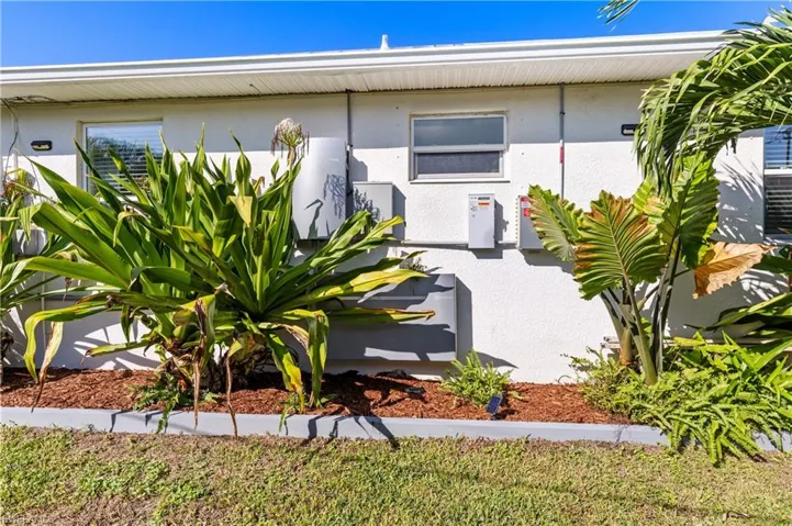 Side view of home showing battery backup for electrical and solar panels
