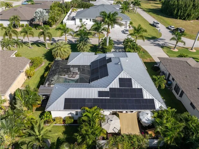 Aerial view of home with metal roof and solar panels