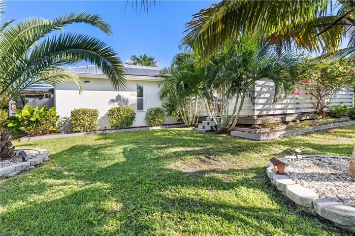 View of private deck and grassy yard