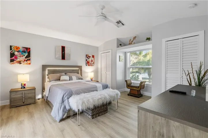 Guest Bedroom with multiple closets, lofted ceiling