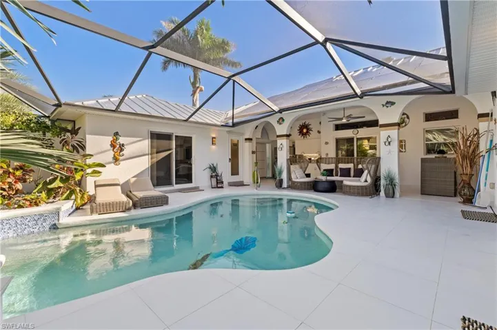Swimming pool featuring a lanai and courtyard