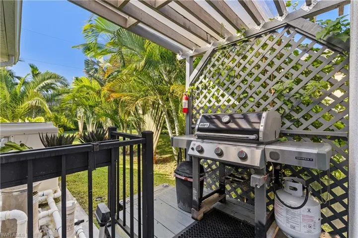 Wooden deck featuring a pergola and area for grilling
