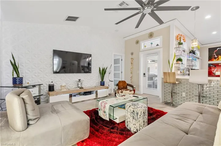 Living room with a ceiling fan, 3D accent wall,