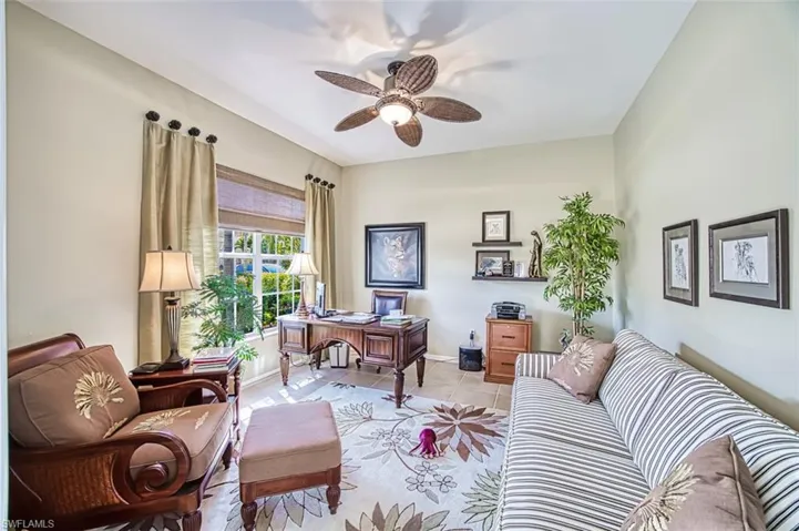 Office with light tile patterned floors, baseboards, and a ceiling fan