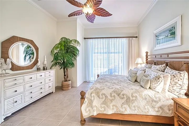 Bedroom featuring light tile patterned floors, baseboards, a ceiling fan, and crown molding