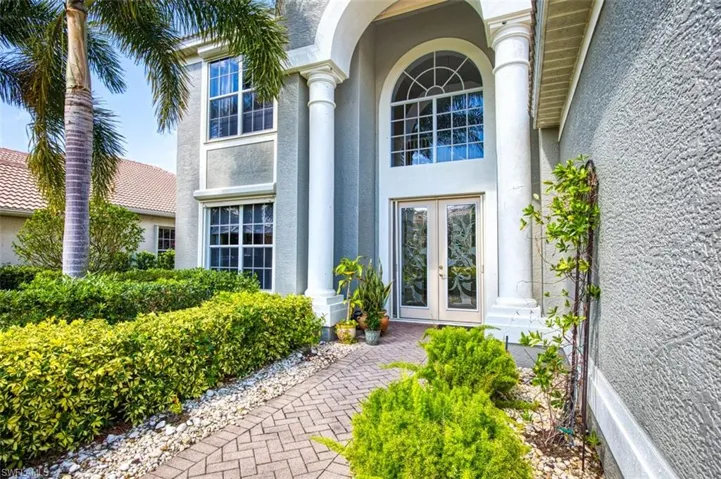 Doorway to property featuring stucco siding and french doors