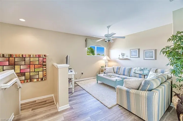 Living area with light wood-type flooring, ceiling fan, baseboards, and recessed lighting
