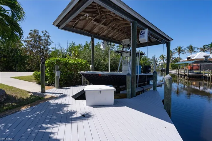View of dock with boat lift and a water view