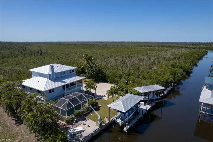 Bird's eye view with a water view and a view of trees
