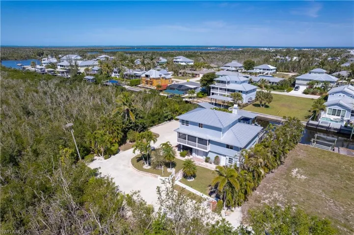 Drone / aerial view with a residential view and a water view