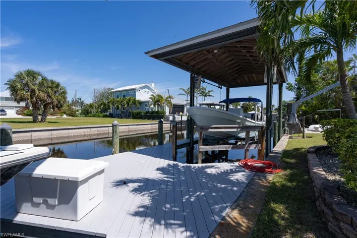 View of dock featuring boat lift and a water view