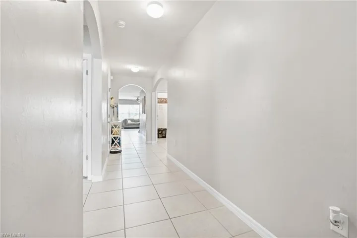 Corridor with light tile patterned floors