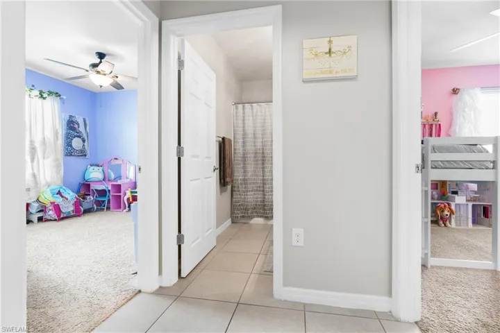 Hallway featuring light carpet