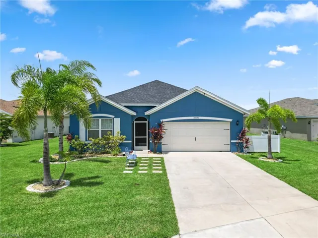 Ranch-style home with a garage and a front yard