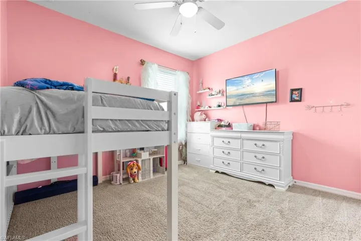 Carpeted bedroom with ceiling fan