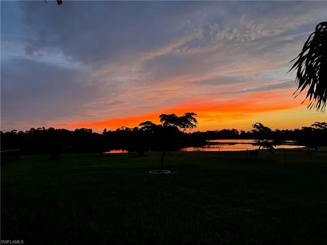 Yard at dusk featuring a water view