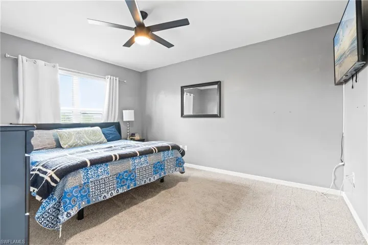 Bedroom featuring carpet and ceiling fan