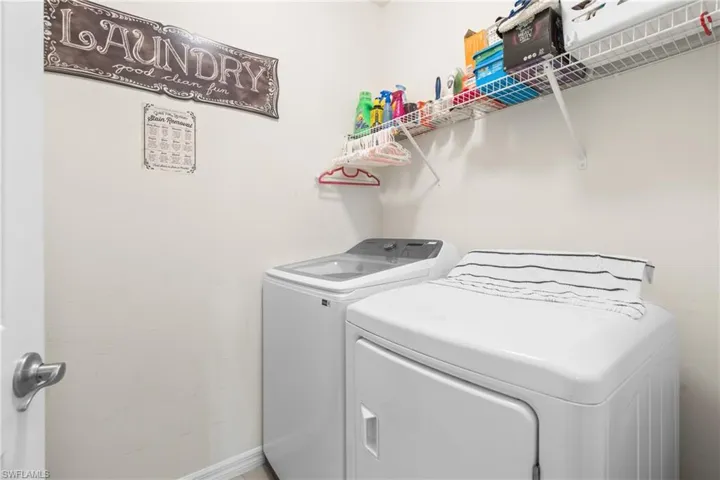 Clothes washing area featuring washing machine and clothes dryer