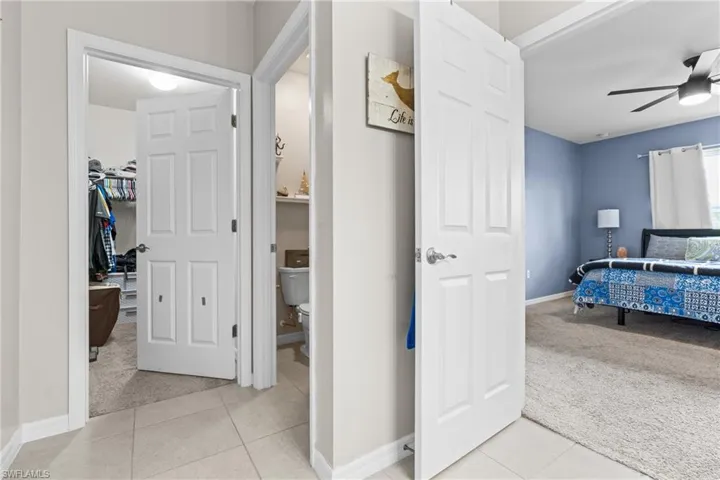 Corridor featuring light tile patterned floors