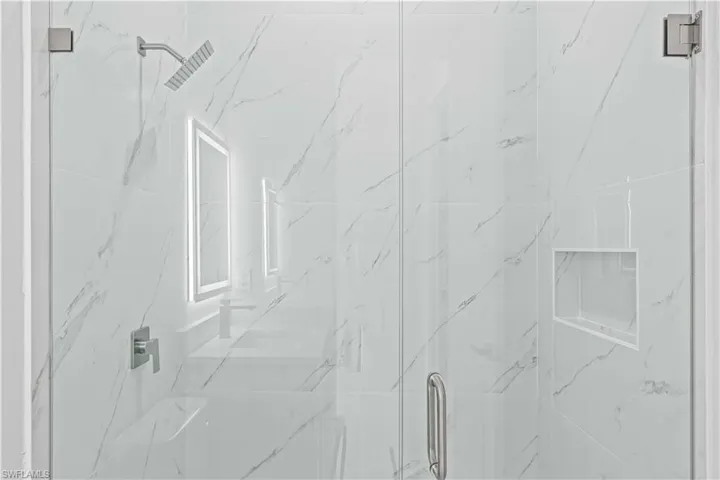 Second full bath with a marble finish shower