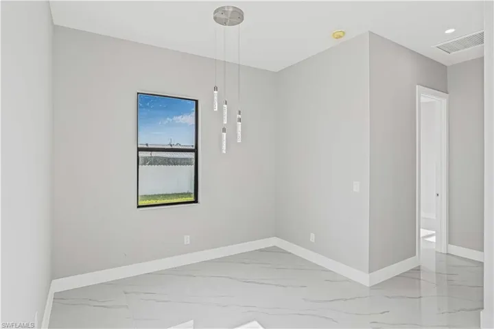 Unfurnished room featuring light marble finish flooring