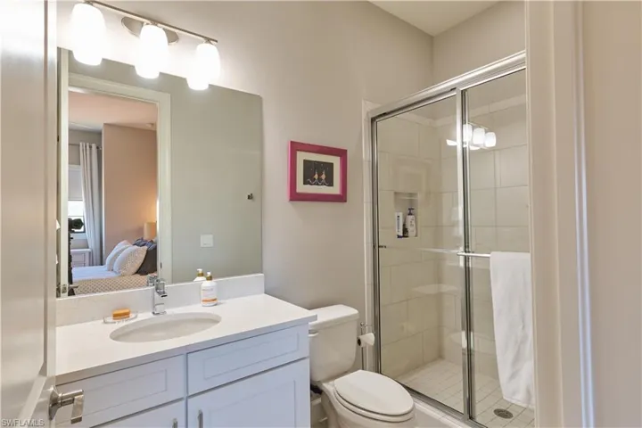 Bathroom featuring a shower stall and vanity