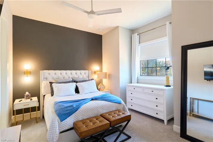 Bedroom featuring light colored carpet and ceiling fan