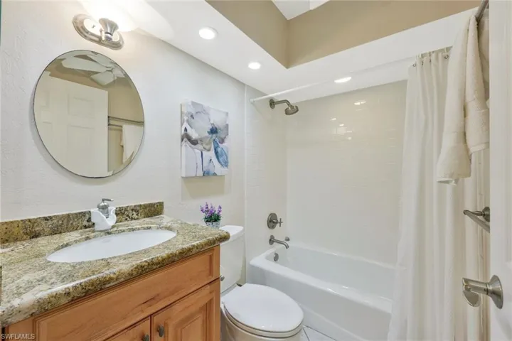 Full bathroom featuring shower / tub combo, toilet, and vanity
