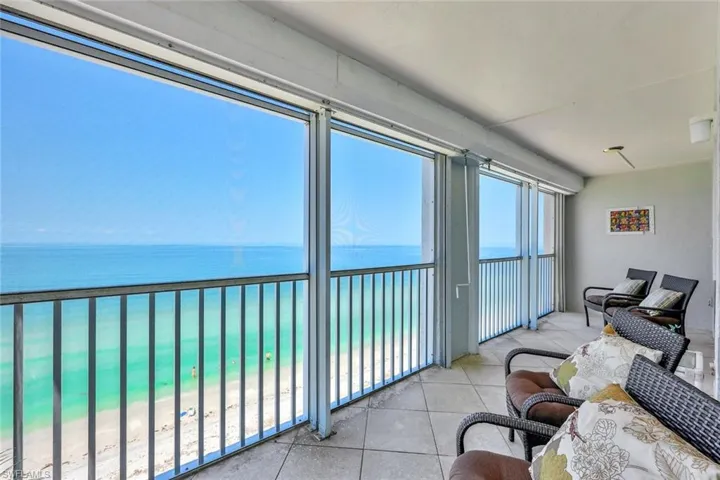 Sunroom featuring a water view