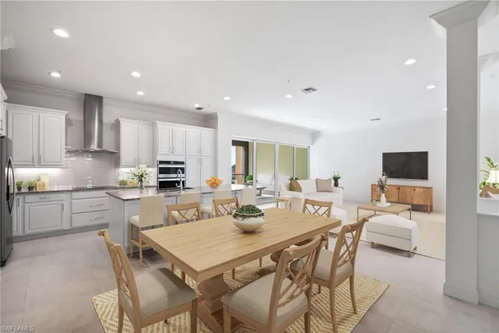 Dining space featuring crown molding and light tile patterned floors