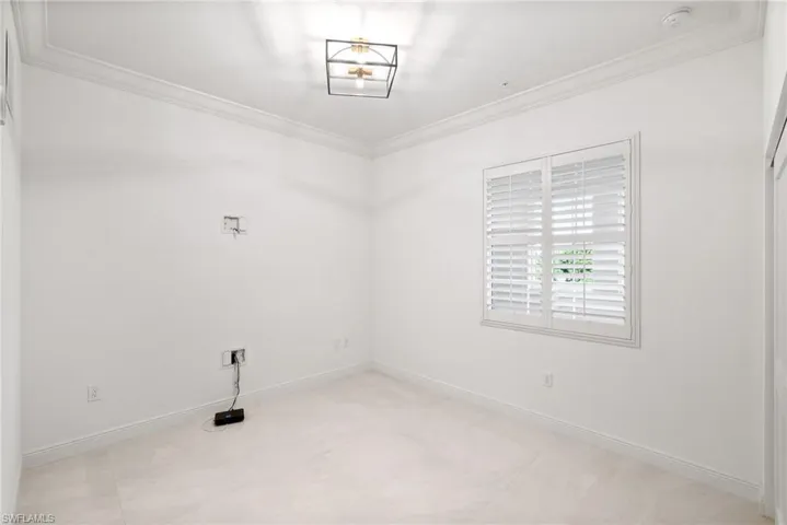 3rd bedroom featuring light tile patterned floors and crown molding