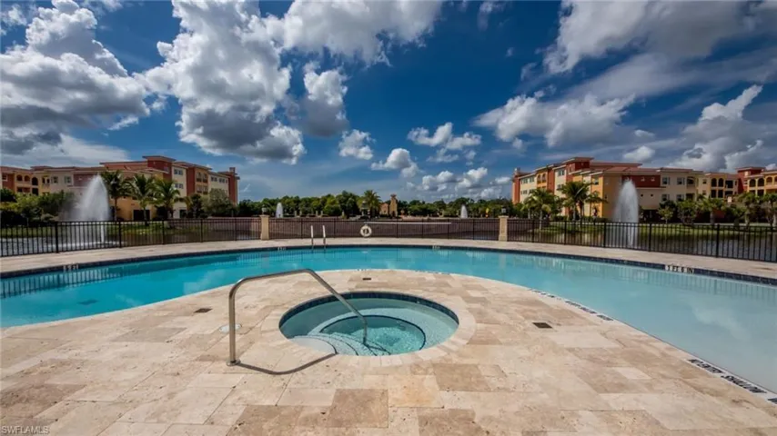 View of swimming pool featuring a community hot tub