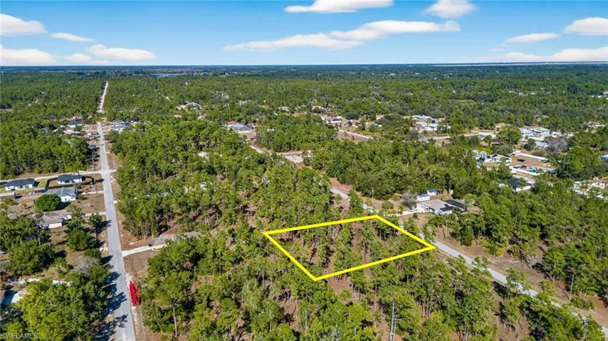 Aerial view of property's location with a forest and property parcel outlined