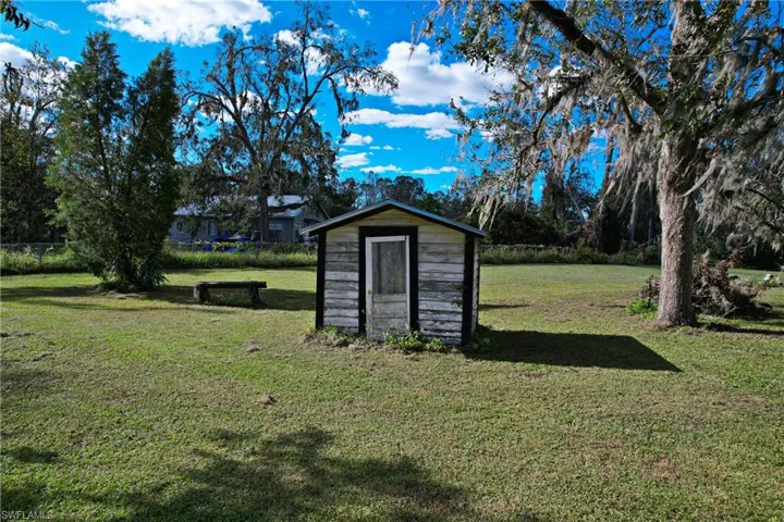 View of outbuilding featuring a yard