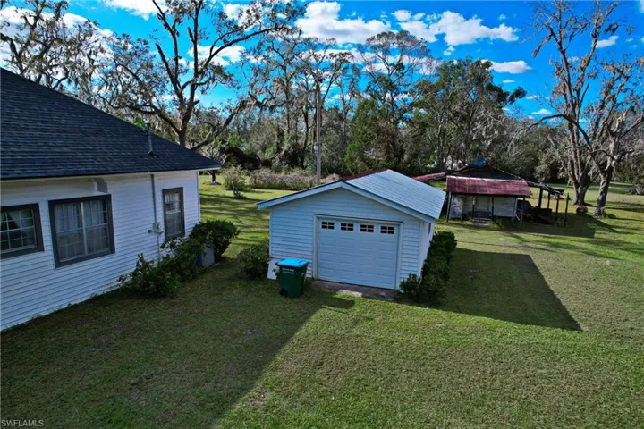 View of yard with an outdoor structure and a garage