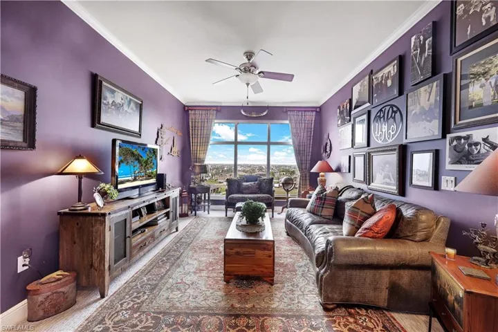 Living area featuring ornamental molding and ceiling fan