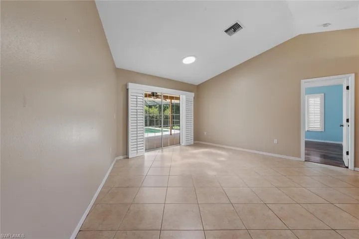 Formal Living Room featuring light tile flooring and lofted ceiling