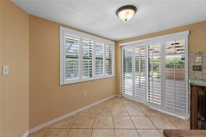 Breakfast area with plantation shutters and sliding door to patio