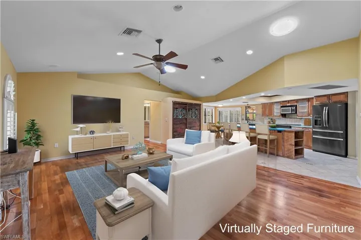 Family room and kitchen are open concept with a wealth of natural light - furniture has been virtually staged