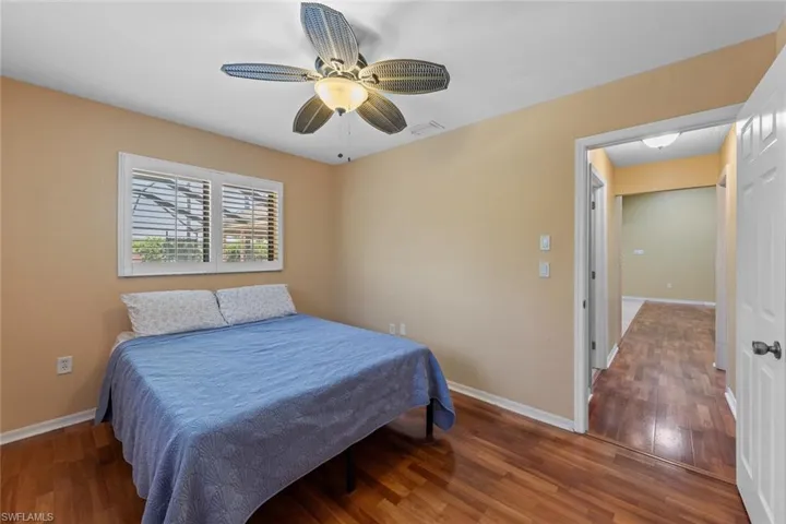 Bedroom 3 featuring wood-type flooring and ceiling fan