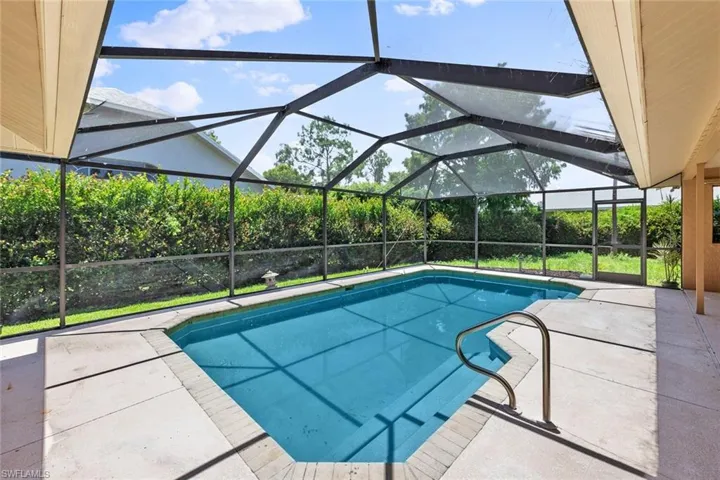 View of pool featuring a patio area and a lanai
