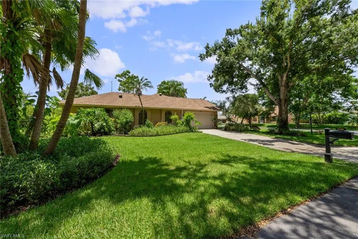 Corner lot home featuring a side entry garage and large driveway