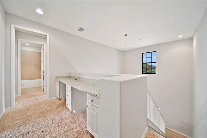 Hallway with light colored carpet