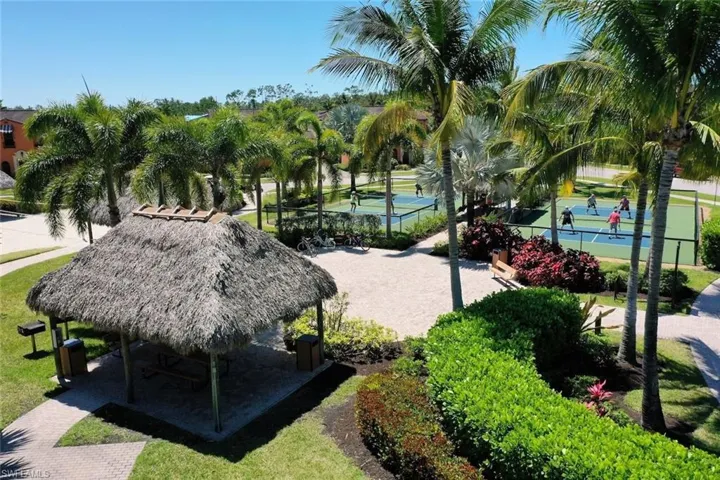 View of home's community featuring tennis court