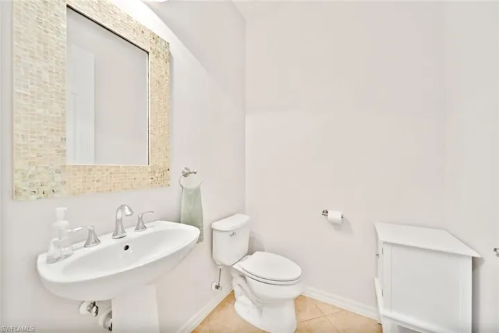 Bathroom featuring sink, tile patterned flooring, and toilet